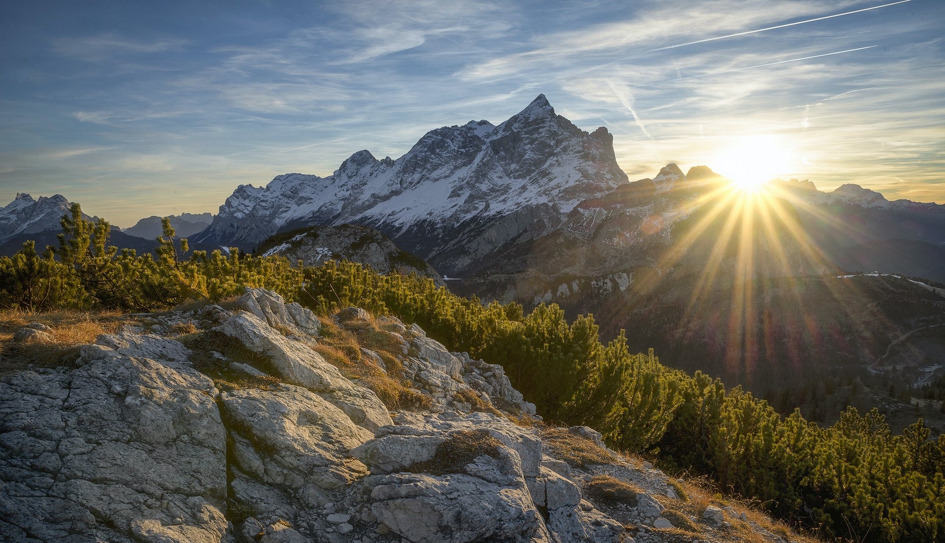 Photo of mountains and the sun peeking over the top